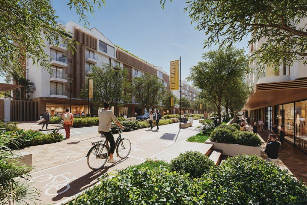 A modern, eco-friendly urban development in Sotogrande featuring residential buildings, green landscaping, bike paths, and retail spaces.