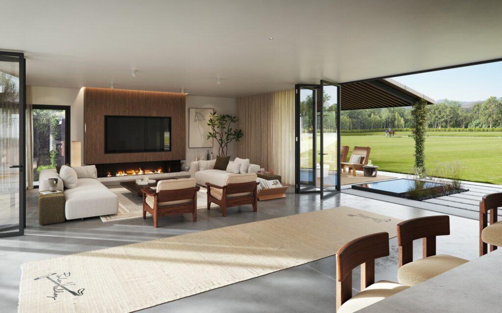 Modern luxury living room with fireplace and open views to a polo field in Sotogrande, blending indoor comfort with outdoor elegance.